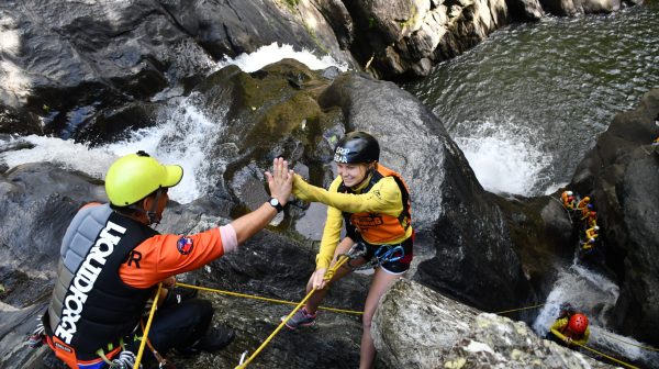 Visitors enjoy waterfalls and cairns in the rainforest at Crystal Canyon