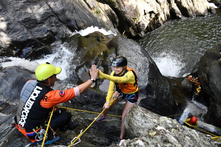 Visitors enjoy waterfalls and cairns in the rainforest at Crystal Canyon