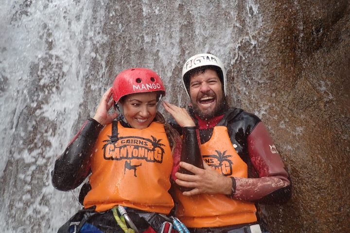 two people smiling and enjoying waterfalls cairns