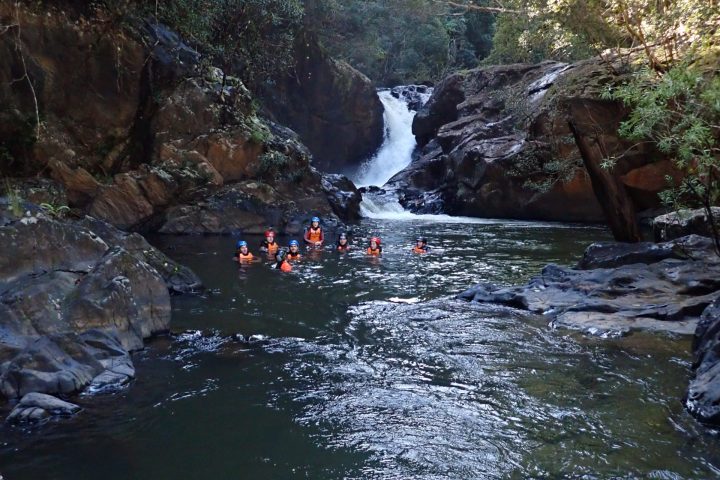 Participants on the Adventure Rainforest Full Day Tour at a cairns waterfall
