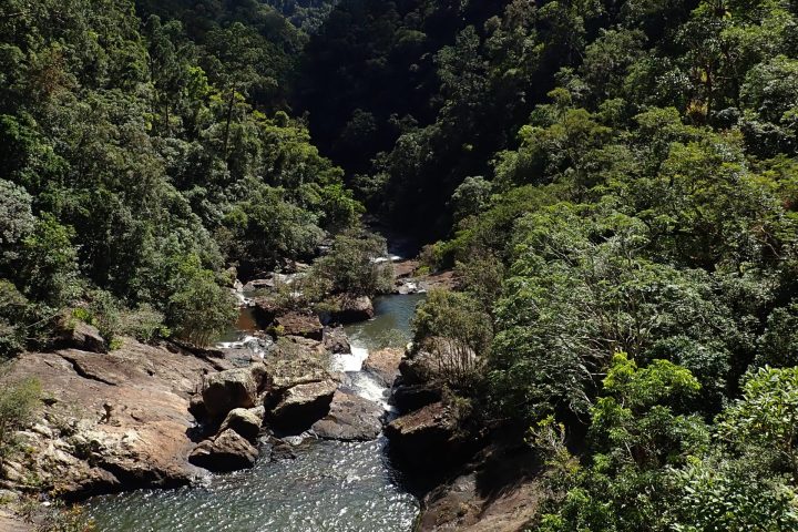 Participant on the Spillway Full Day Canyon Experience at a cairns waterfall