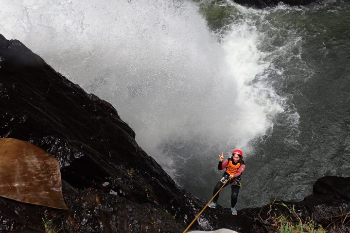 Participant on the Spillway Full Day Canyon Experience at a cairns waterfall