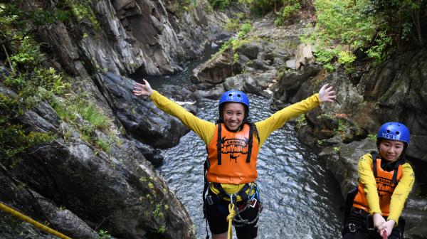 two people having fun while abseiling cairns waterfalls