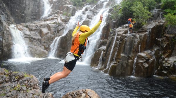 A girl experiencing and having fun cairns waterfalls
