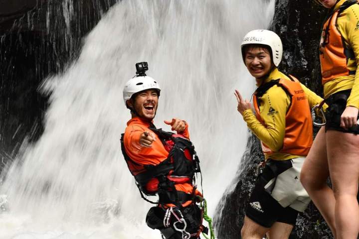Having fun while abseiling cairns waterfalls